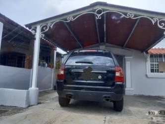 Open floor plan living and dining room with tile floors in house for sale Vacamonte Panama