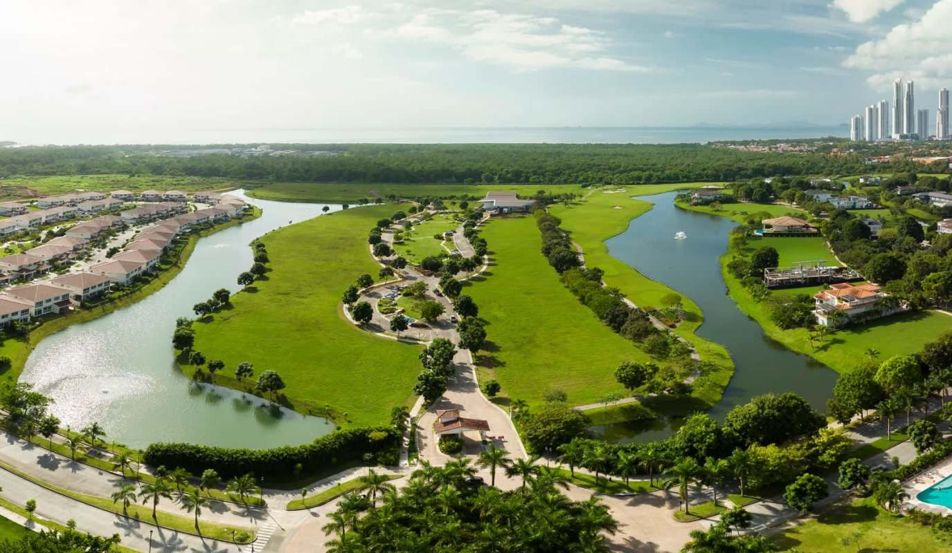 Aerial golf fairways, man-made lakes, landscaped luxury community Panama City