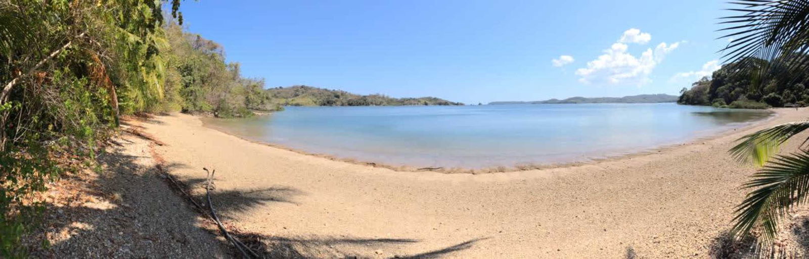 Soft sand shoreline lush landscape and distant hills Las Perlas Panama