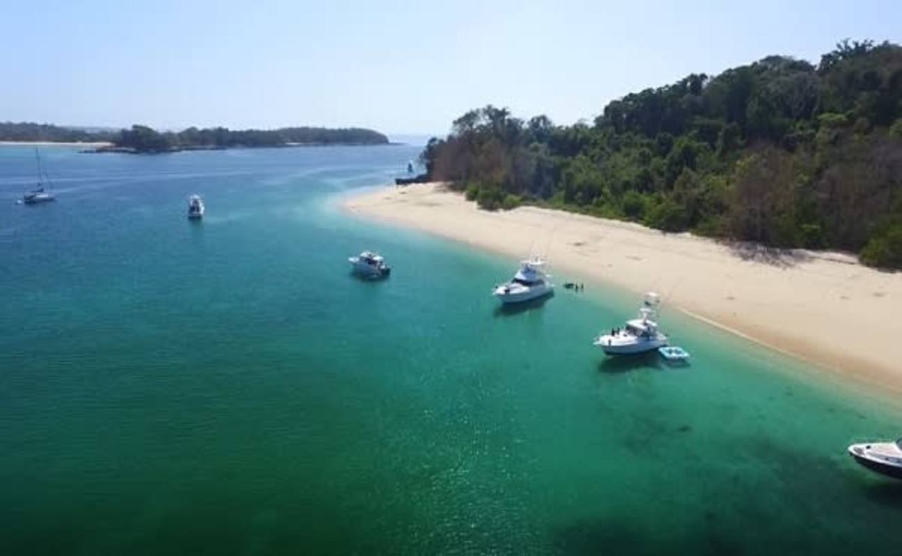 Aerial pristine coastal bays boats anchored lush forest Las Perlas archipelago