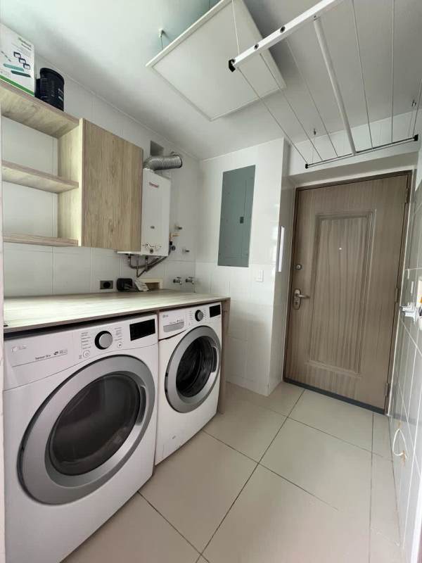 Modern laundry room with washer dryer wood cabinets in PH Forest Gate Albrook Panama
