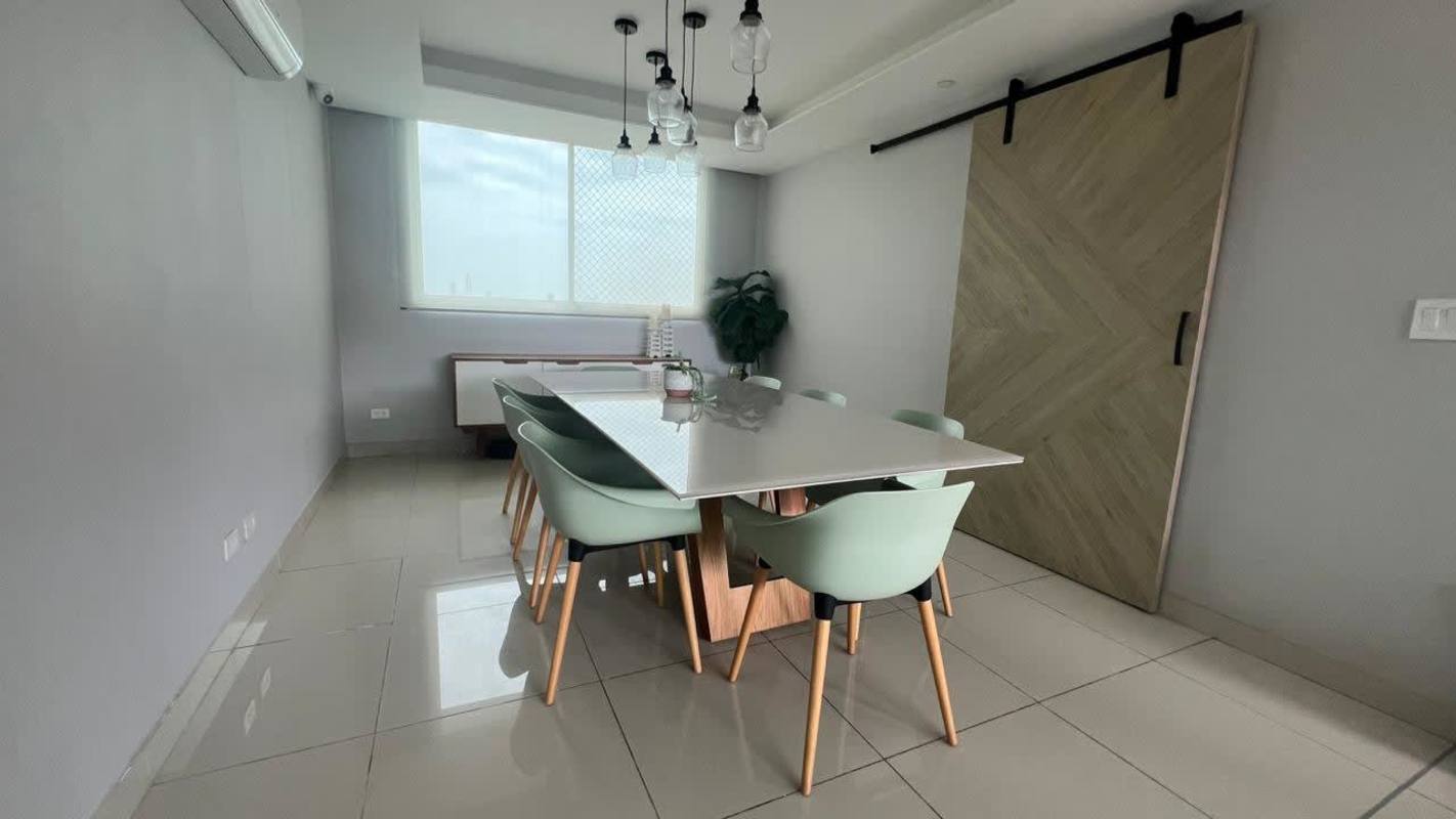 Bright dining area with mint chairs barn door pendant lights PH Forest Gate Panama