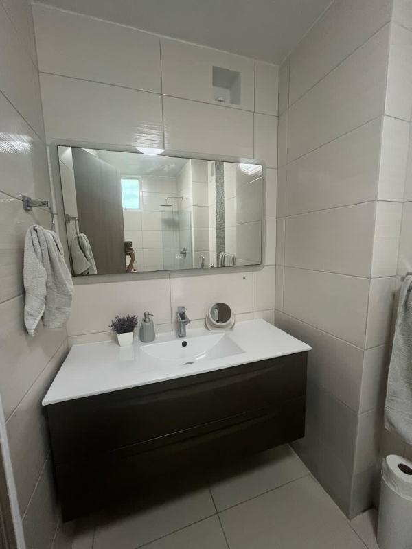 Bathroom with large mirror wall vanity beige tile PH Forest Gate Albrook Panama