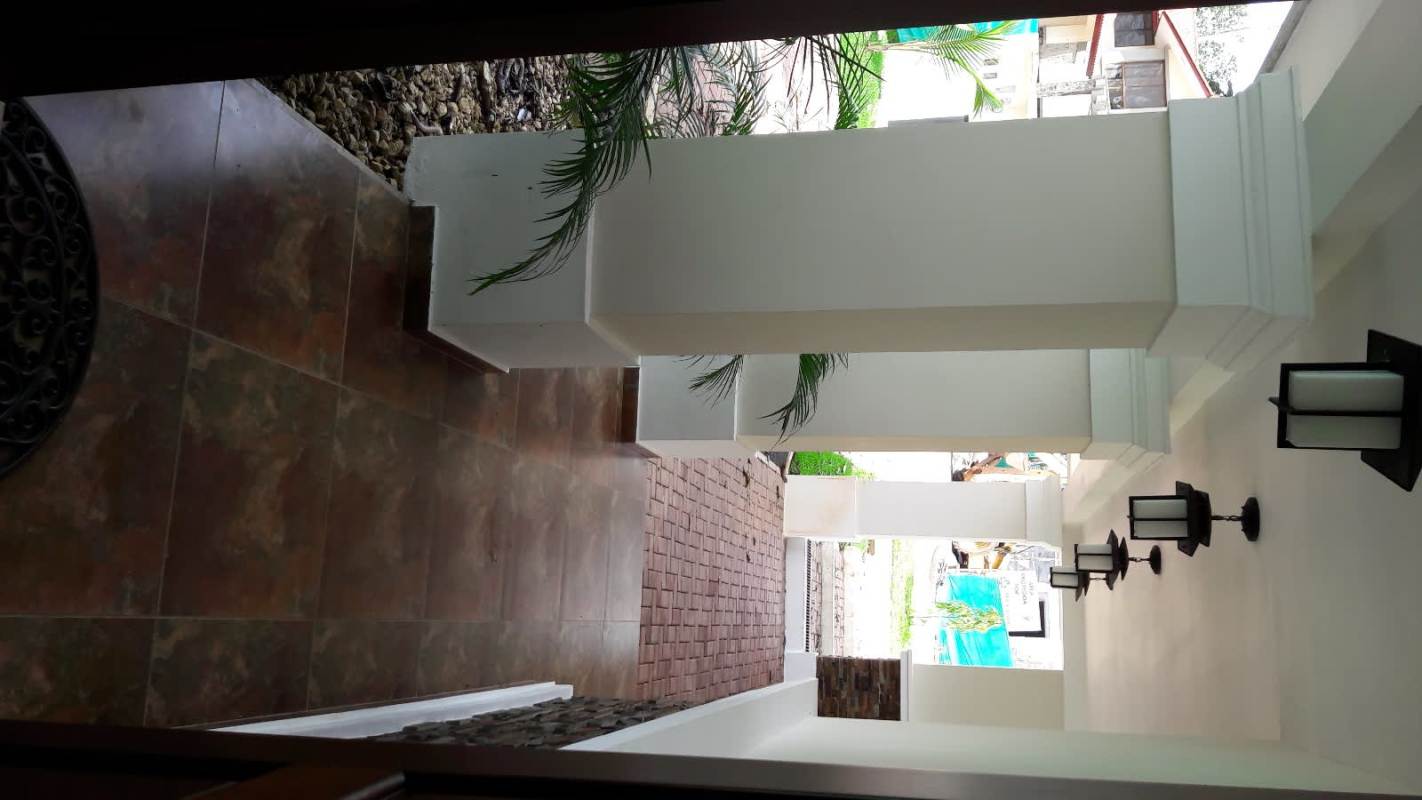 Luxury covered entrance with columns and garden view Senderos de Cruces Panama