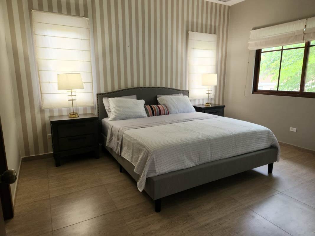 Modern decorated living room blue sofa accent wall luxury Panama house Senderos de Cruces