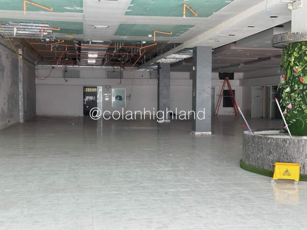 Large open commercial space with tile floors, recessed lights, exposed ceiling panels at Plaza Costa Sur Panama City