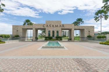 Modern open plan living dining with blue accents and balcony views at Casamar Resort Panama