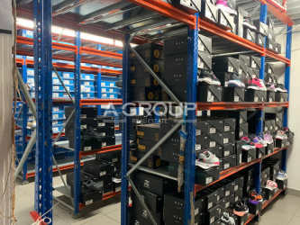 Warehouse space with shelving filled with shoe boxes inside retail store in Westland Mall Panama