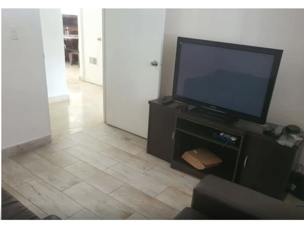Dining area with large sliding glass doors overlooking patio and pool in Panama City