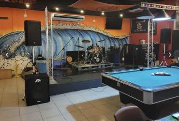 Brightly colored cocktail drinks on wooden bar at Sandbar Gastropub Playa Coronado Panama