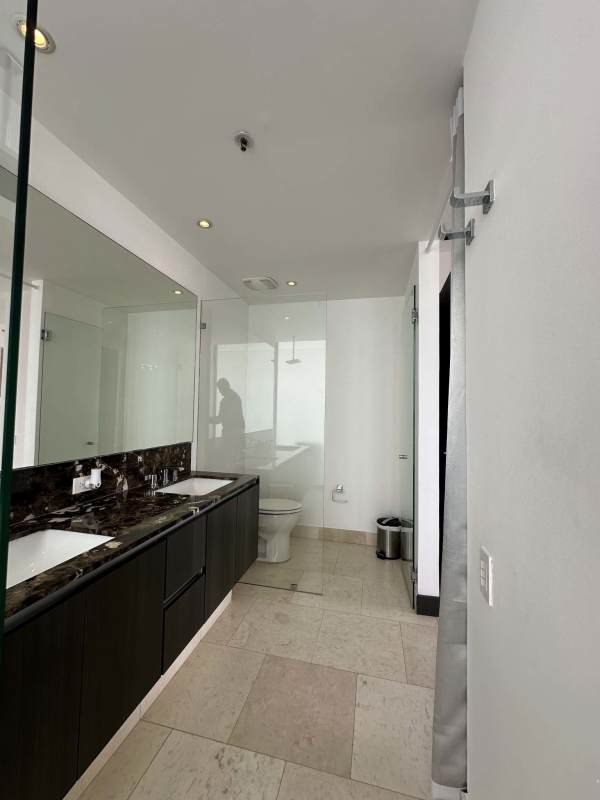 Luxury bathroom with double marble vanity and glass shower at PH Ocean Club Panama