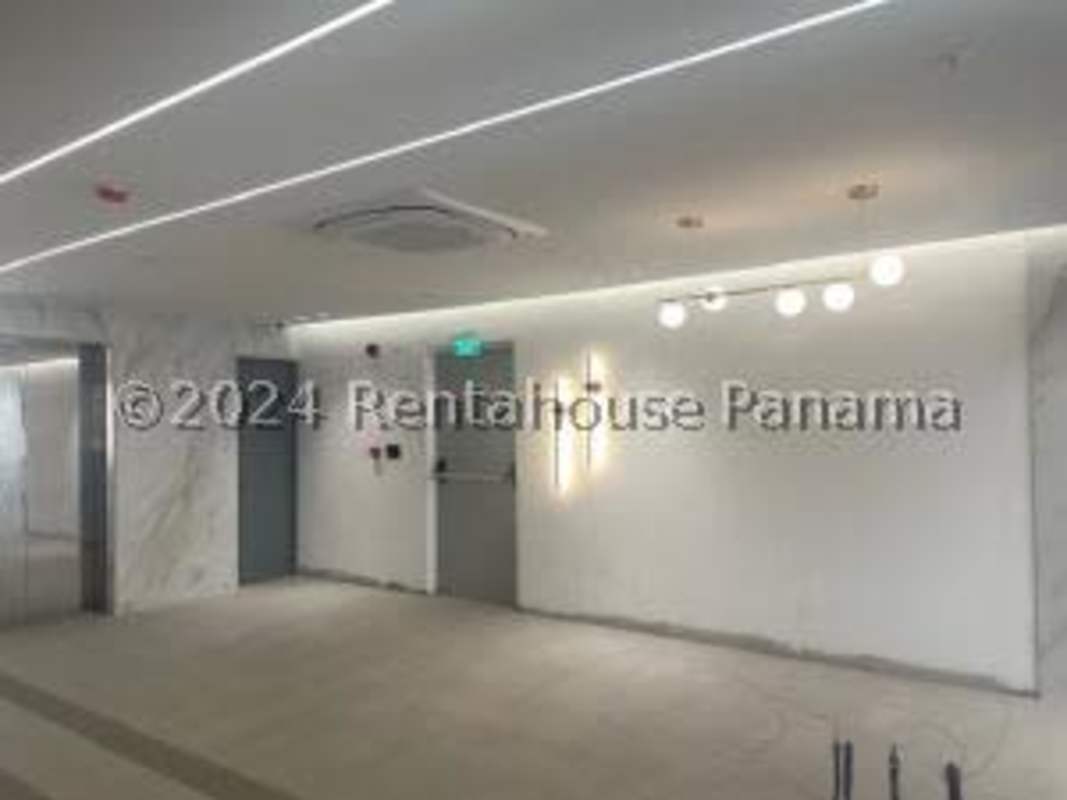 Marble hallway with lighting fixtures in medical office tower lobby Panama City