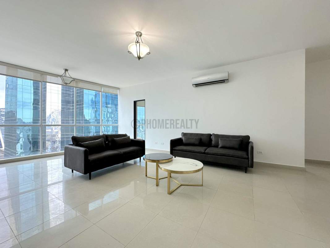 Contemporary living room with black sofas, large glass windows, city skyline views in PH Metropolitan Park Panama City