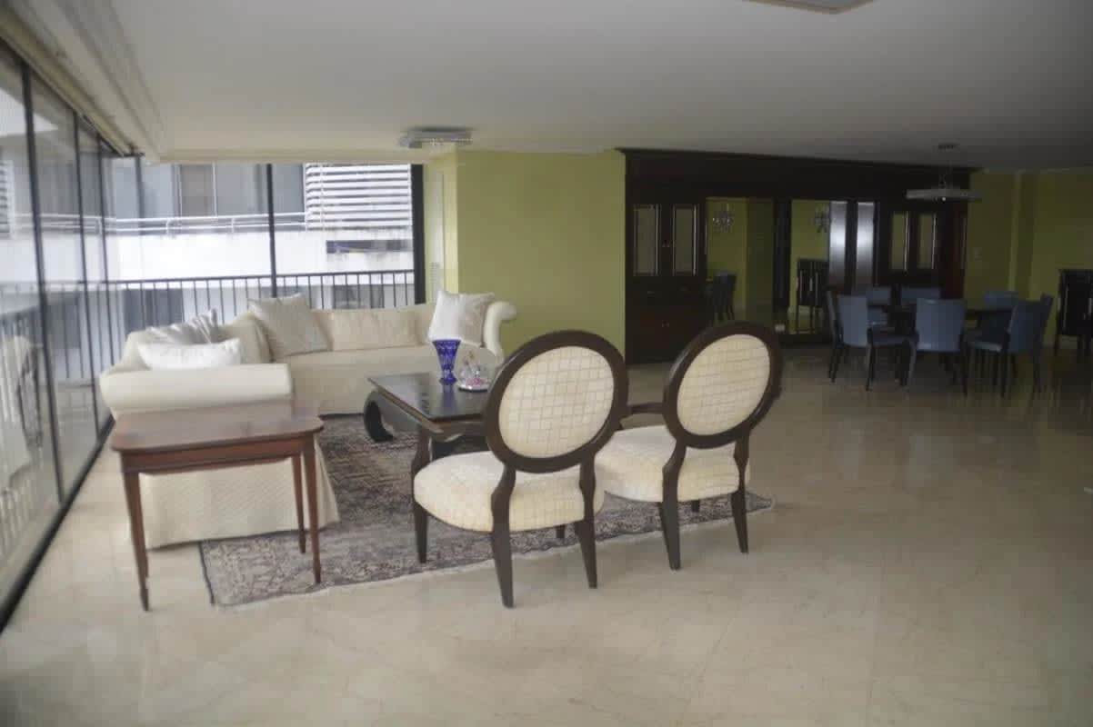 Elegant dining area with panoramic windows, marble floors in luxury condo PH Alcazar