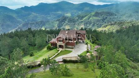 Grand living area with high ceilings, chandeliers, almond wood floor, mountain views in Altos del María luxury estate Panama