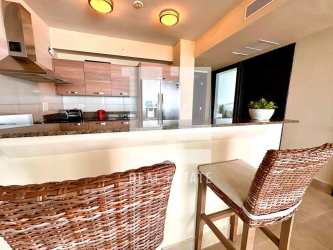 Granite countertop kitchen with stainless appliances and breakfast bar in Panama beachfront condo Rio Mar
