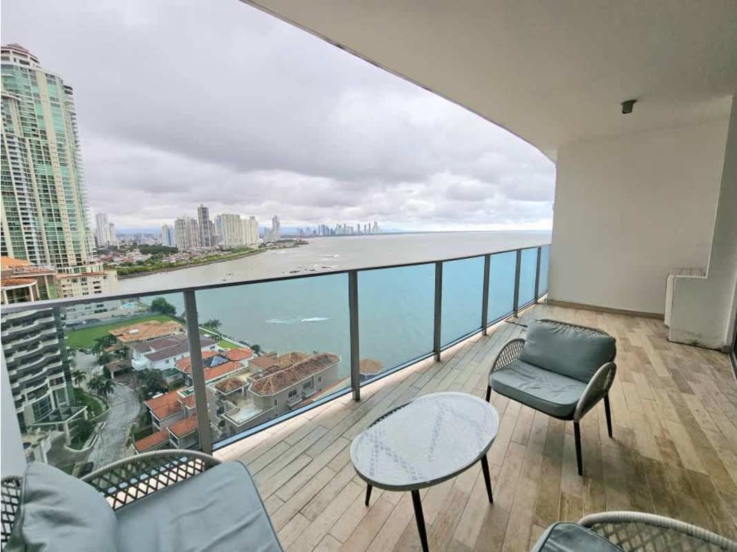 Dining space with glass walls offering city skyline and Pacific views at PH Grand Tower