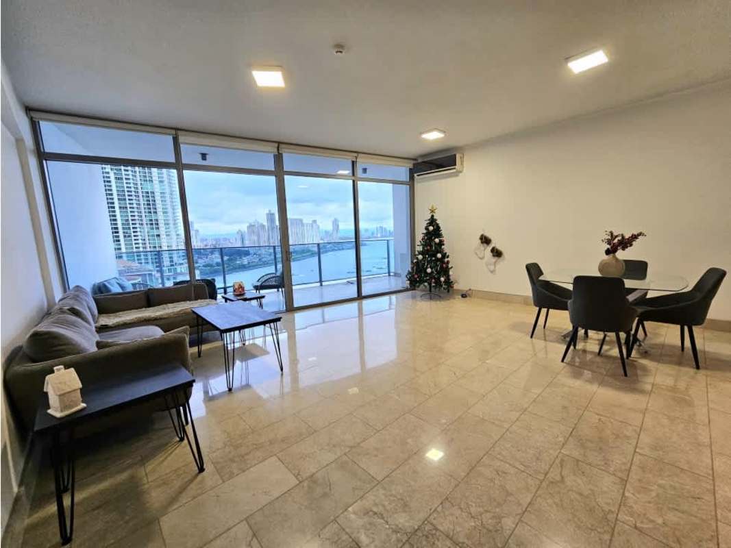 Living and dining area with floor-to-ceiling windows overlooking the ocean in PH Grand Tower Punta Pacifica