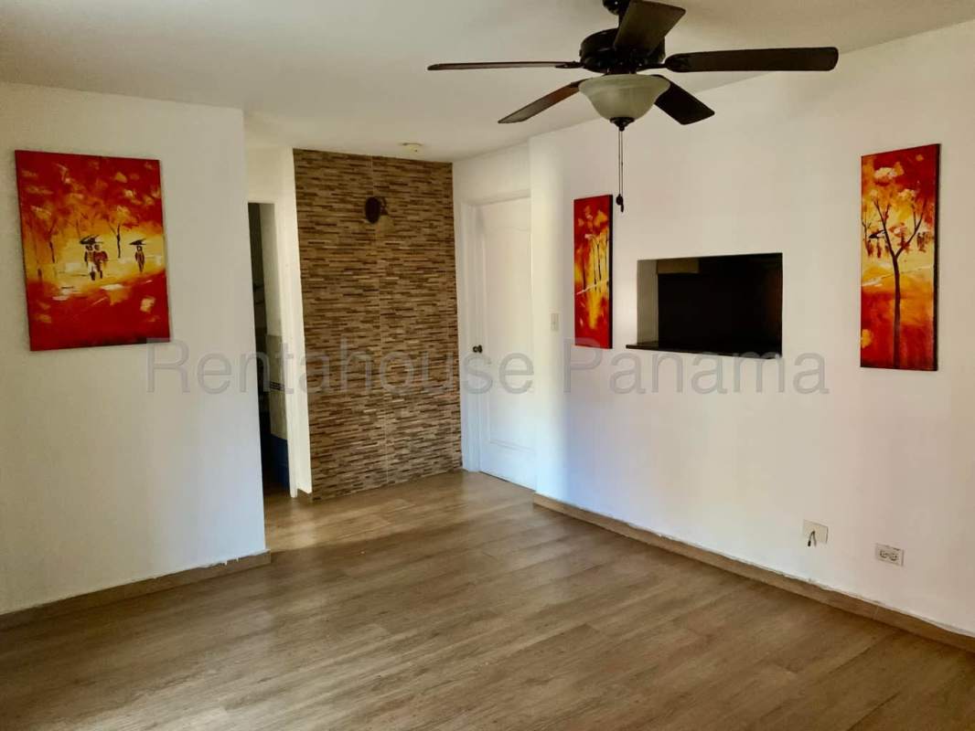 Compact kitchen with ceramic tile, wooden cabinets, laundry area in Condado del Rey apartment Panama