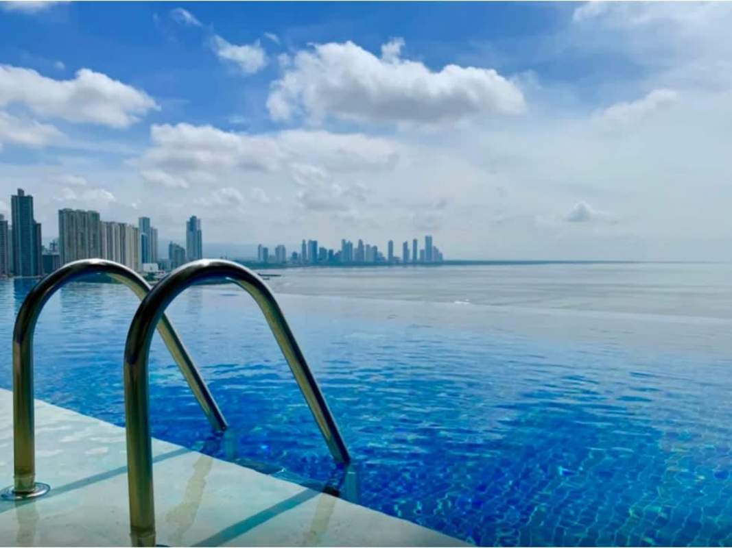 Lounge terraces with palm trees waterfront and skyline views in PH The Ocean Club Panama