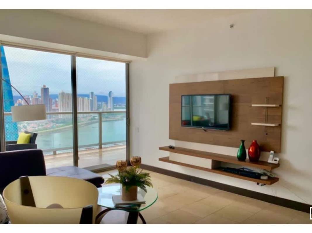 Dining area with modern furniture, waterfront city view at PH The Ocean Club Panama City