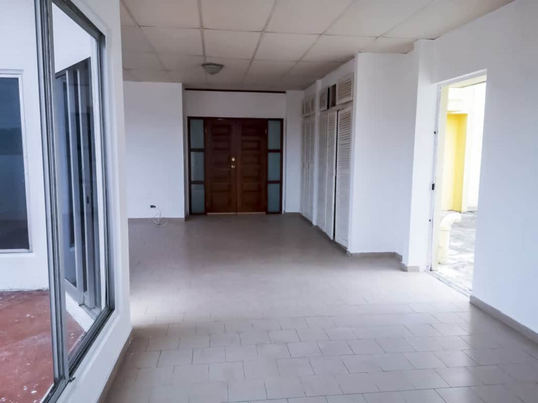 Bright living room with tiled floor and panoramic windows at PH Villa de las Fuentes in El Dorado Panama