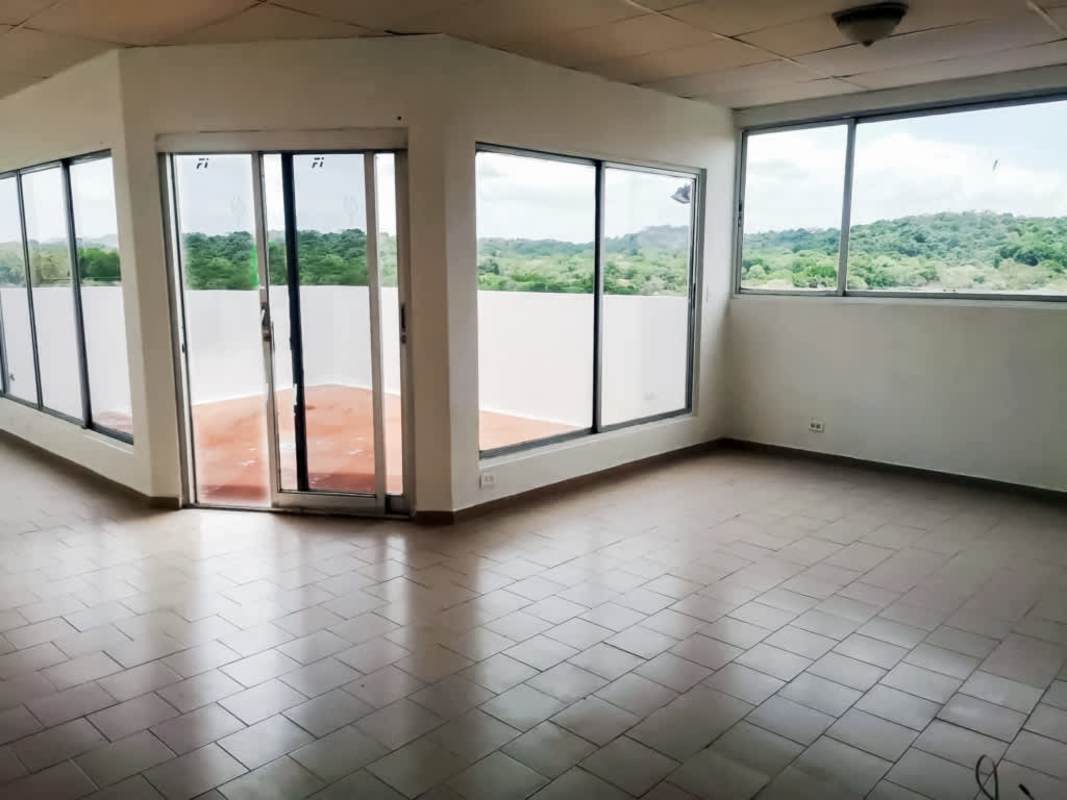 Unfurnished penthouse bedroom with louvered doors closet and window view of Panama City