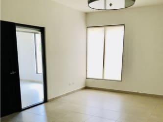Modern bedroom with tile floors and large window in PH Nativa corner property Panama Pacifico