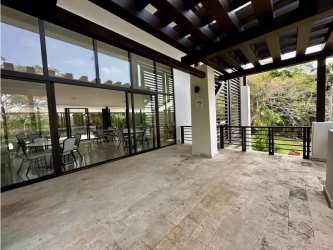 Spacious covered outdoor terrace with garden views in corner PH Nativa home Panama Pacifico
