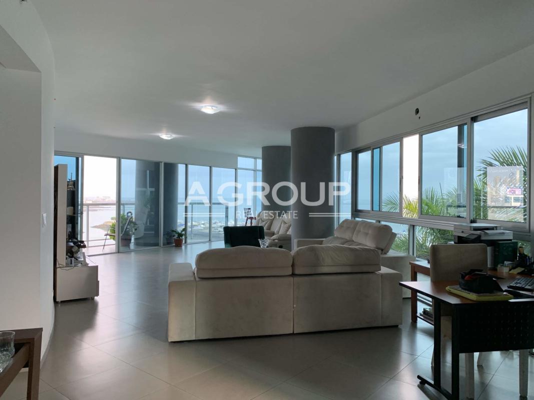 Modern spacious living room panoramic windows ocean and city views Yacht Club Tower