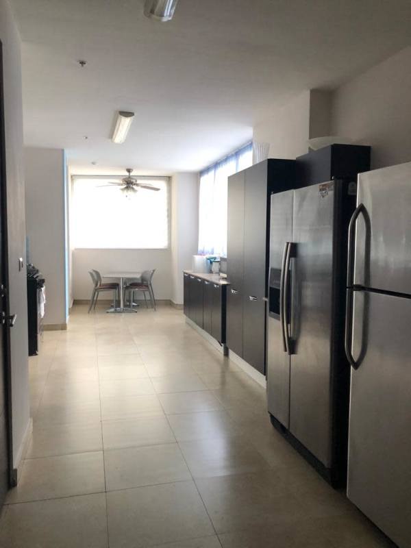 Sleek modern kitchen with quartz countertops, island, stainless appliances at PH Pearl at the Sea Panama