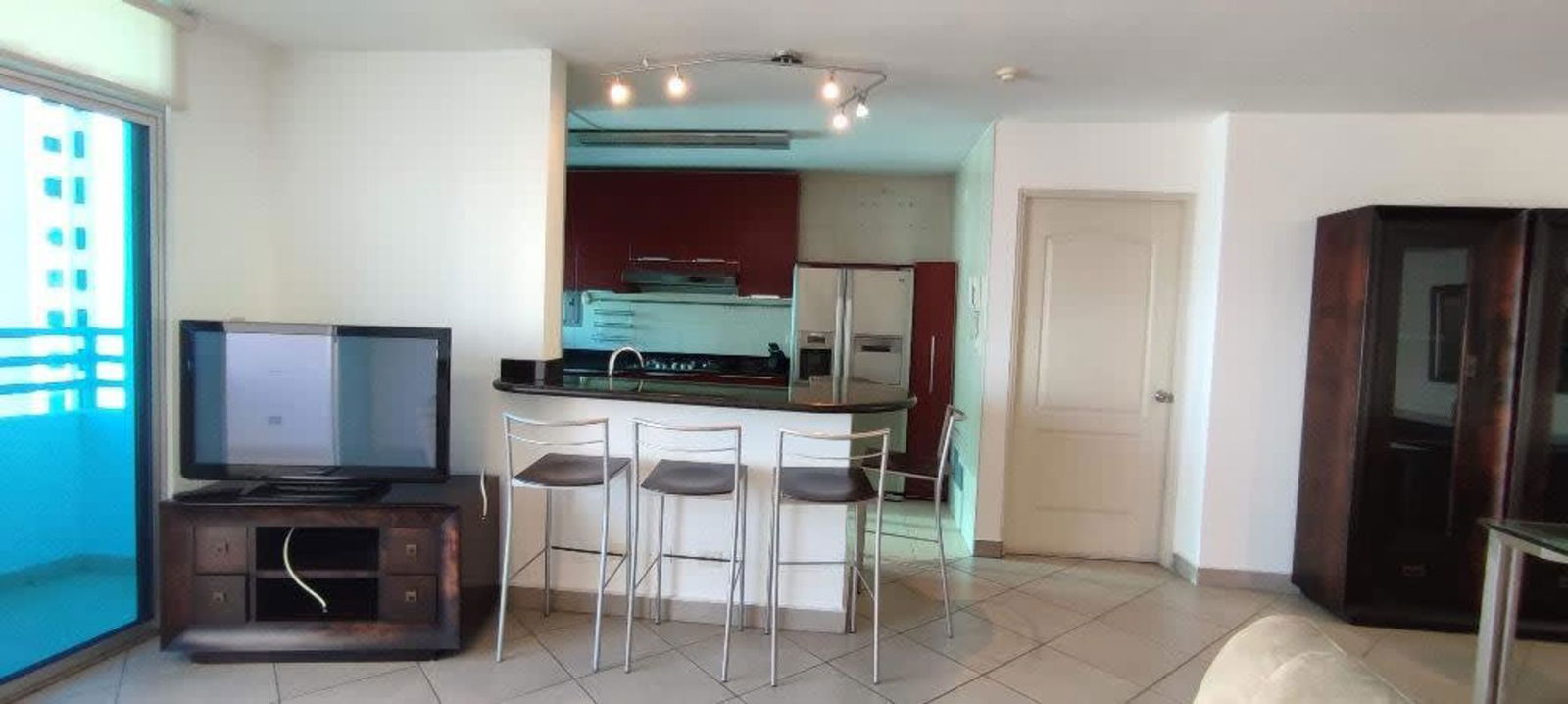 Modern red kitchen with granite countertop and breakfast bar PH Palma de Mallorca San Francisco Panama