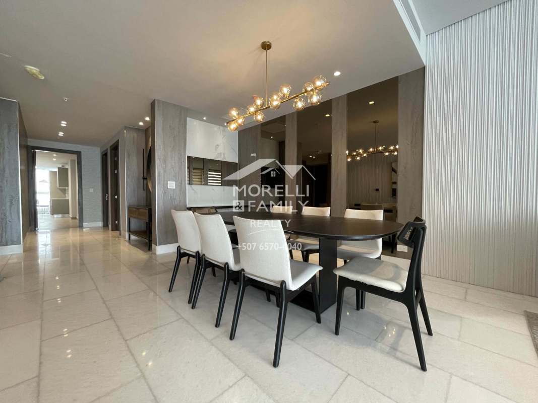 Open plan dining and living area with floor-to-ceiling windows and ocean views in Punta Paitilla Panama