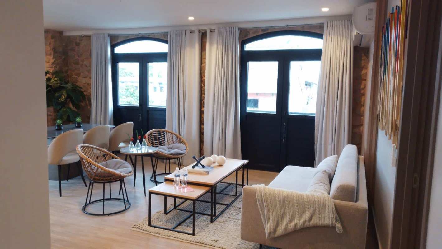 Contemporary kitchen with island seating, stainless appliances, and designer backsplash PH La Cuadra