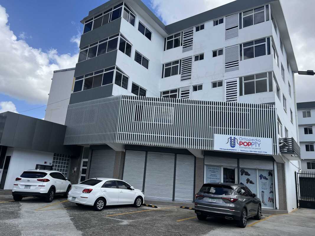 Modern commercial residential building with glass, metal louvers at PH Villa Hermosa Panama