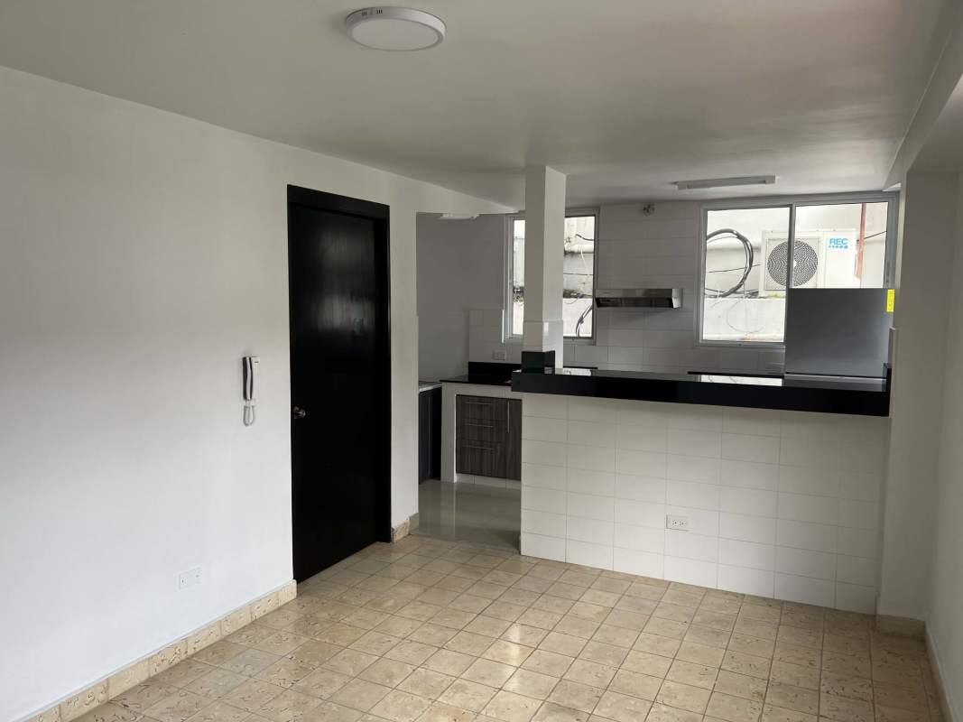Open kitchen with black countertop, white tile backsplash in PH Villa Hermosa Via España