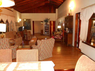 Living room with vaulted wood ceiling, large windows and rustic decor in Casa Romero Boquete Panama