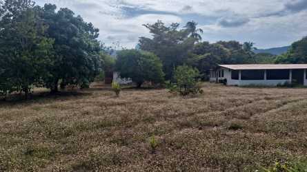 Small rural house surrounded by fenced yard and mountain view in Capira Panama