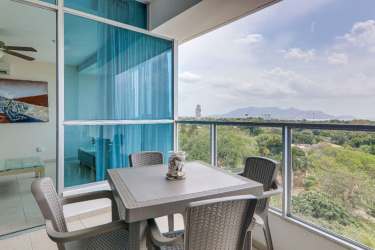 Furnished kitchen with granite tops, appliances, and breakfast bar at PH Coronado Bay Coronado Panama