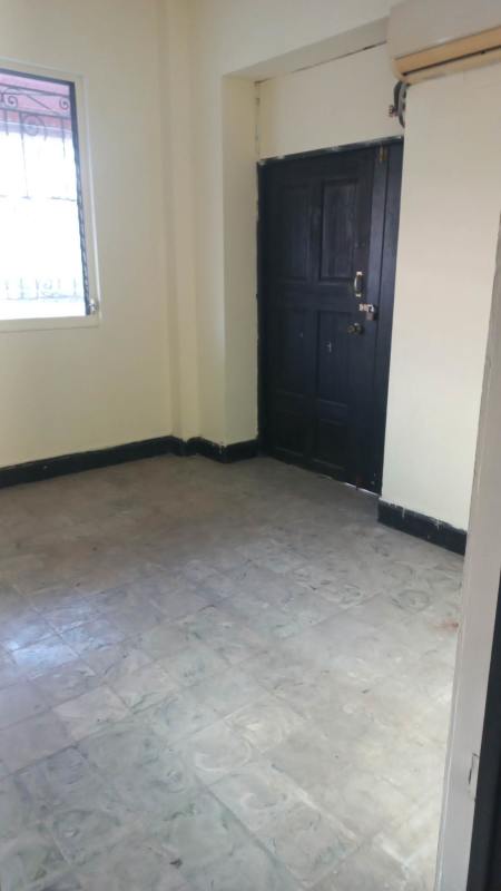 Unfurnished office interior room with tiled floor and window barred in La Cresta Panama City