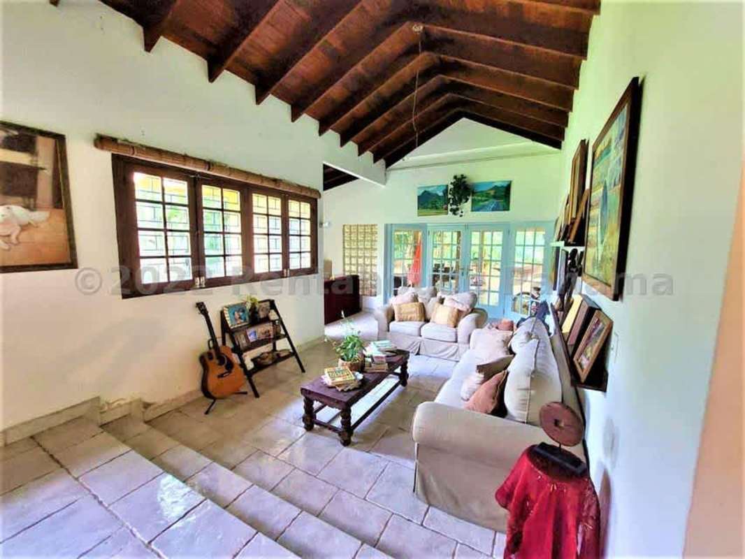 Covered patio with hammock, dining set, ceiling fans surrounded by greenery Las Cumbres Panama