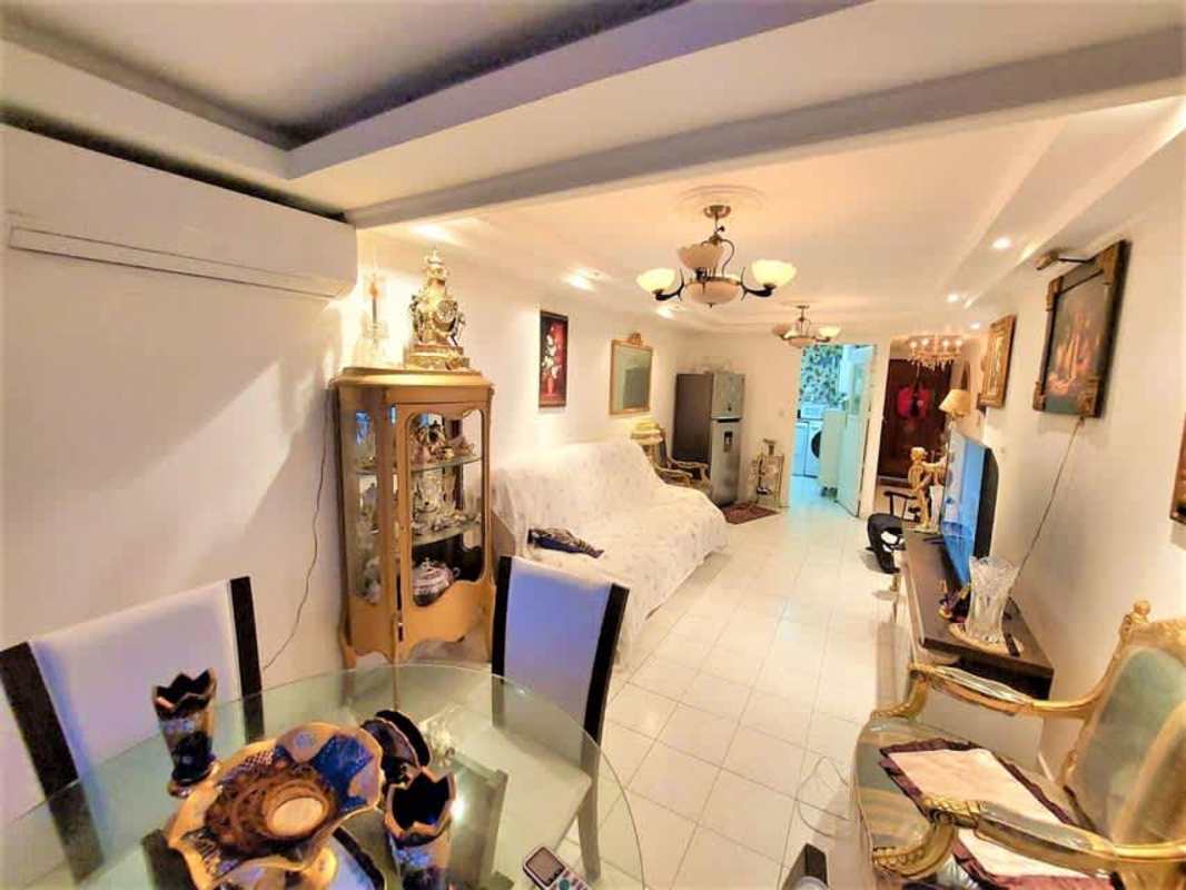 Traditional bedroom with large window, tile flooring inside Villas Costa del Este Panama