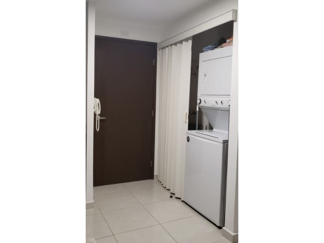 Compact laundry with stacked washer dryer in PH Bayview Avenida Balboa apartment Panama