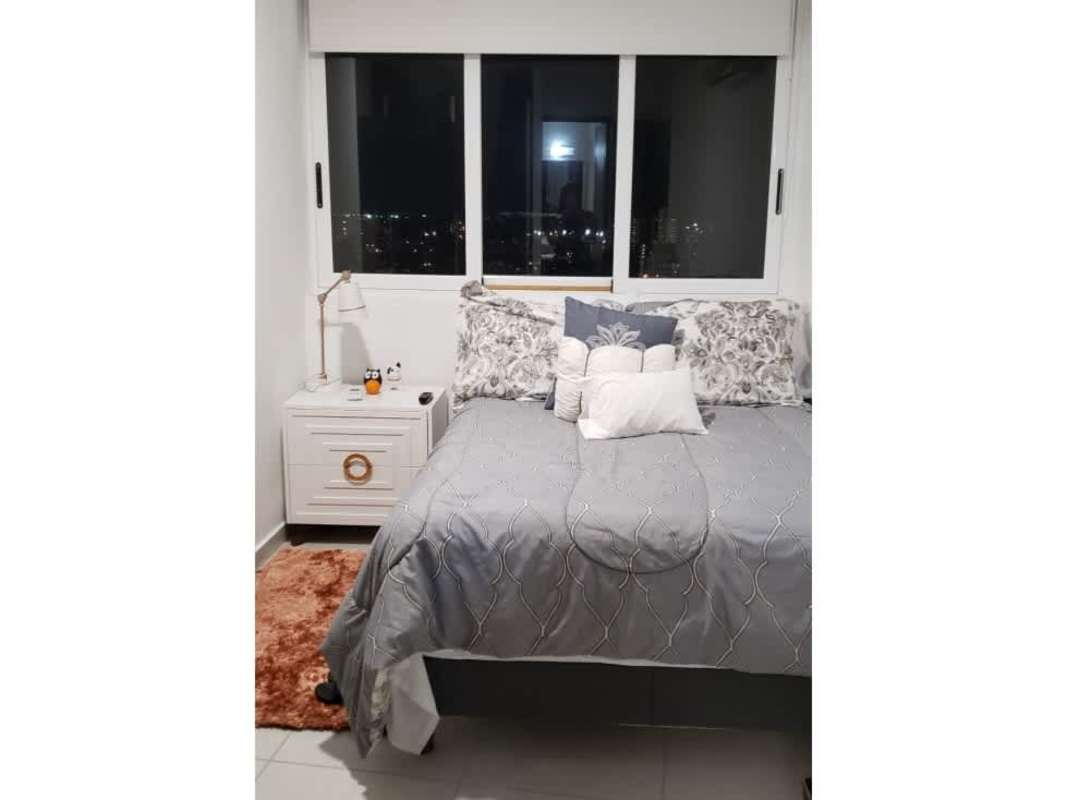 Modern minimalist second bedroom furnished with large city view window PH Bayview Panama