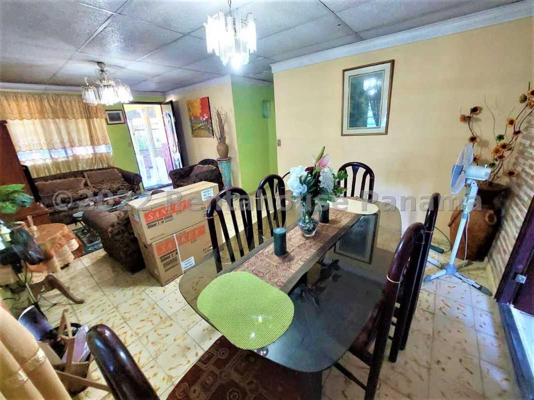 Spacious living dining room with tile floor, chandeliers, sofas in La Cabima Panama house for sale