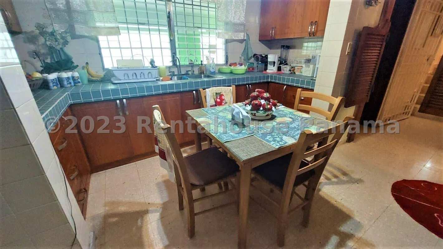 Spacious kitchen with blue ceramic tiles wooden cabinetry dining area La Alameda Betania Panama
