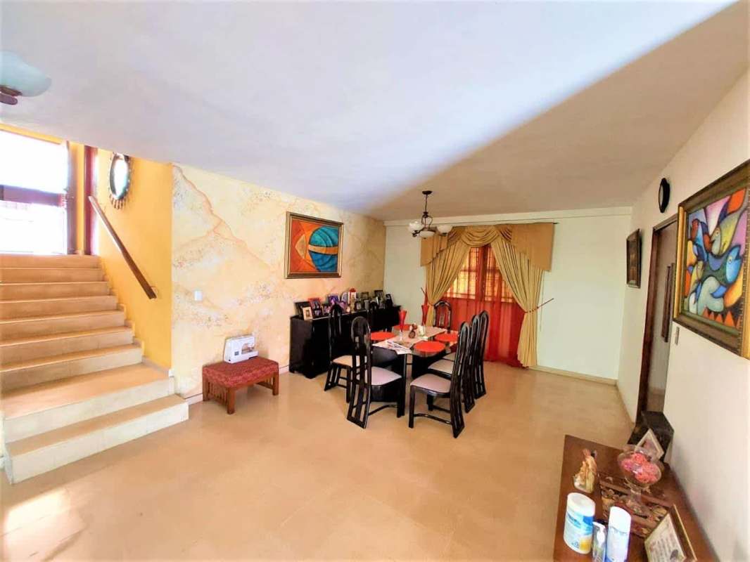 Bedroom with wooden ceiling beams, ceiling fan, large window, wardrobe in Hato Pintado Panama City