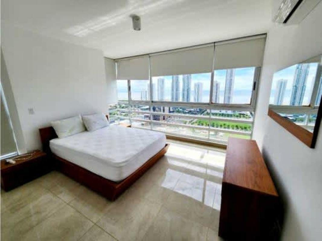 Minimalist bedroom with large window and skyline/sea PH Titanium Tower Panama