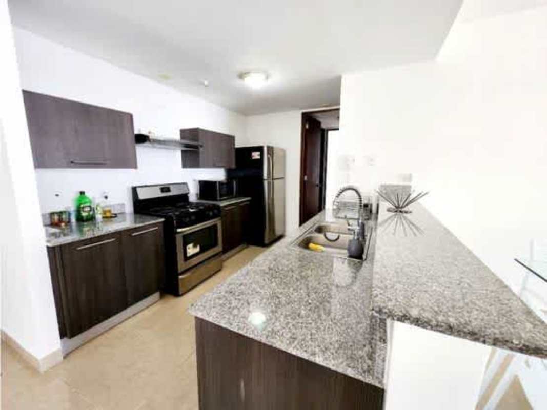 Minimalist living room with sectional sofa and skyline view PH Titanium Costa del Este Panama