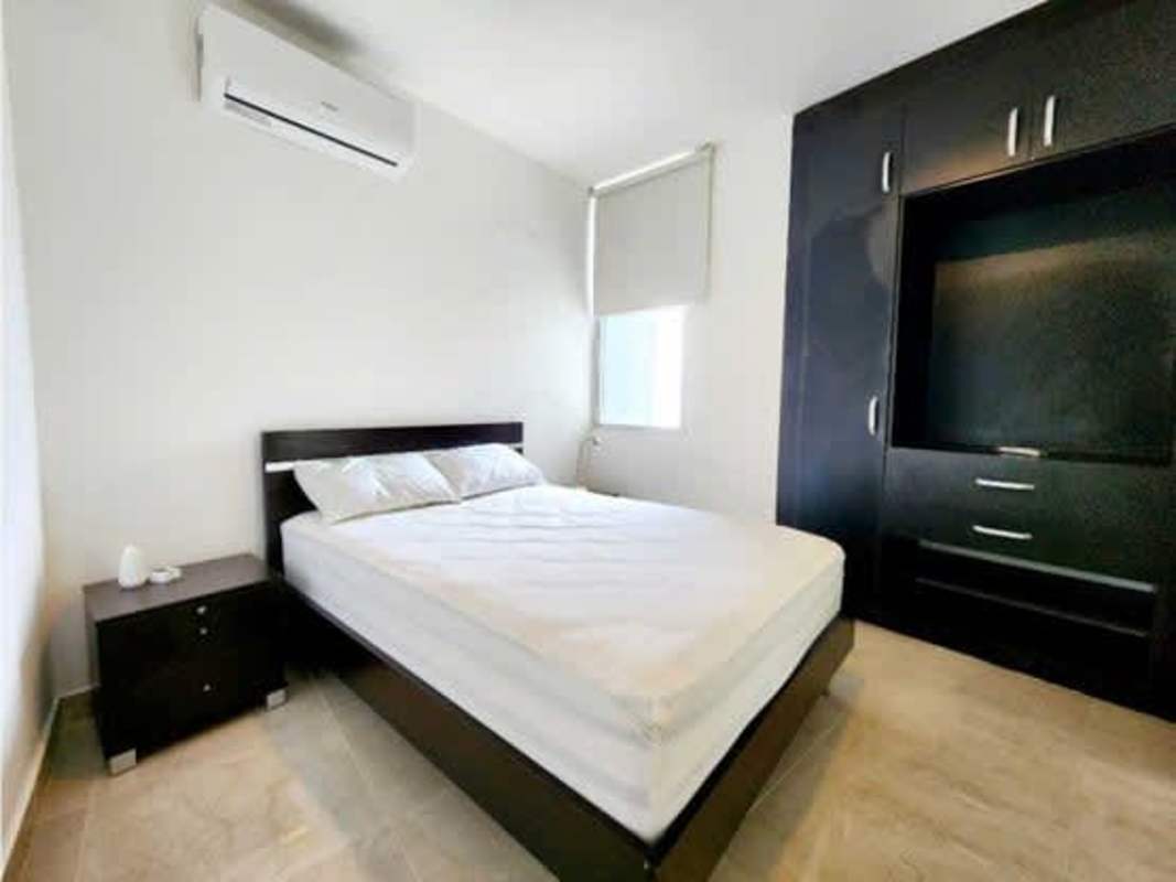 Bedroom with large windows and skyline overlooking Costa del Este in PH Titanium Tower